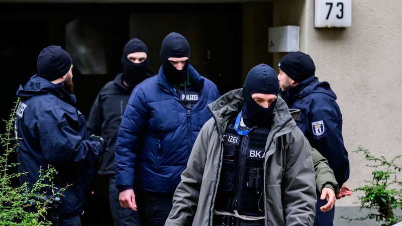 An officer of the German Federal Criminal Police Office at the building believed to be the site where a German activist was (Image: AFP via Getty Images)