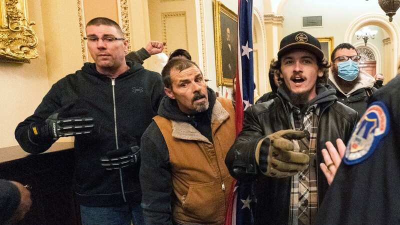 Michael Sparks, left, and Kevin Seefried, second from left, as they and other insurrectionists loyal to President Donald Trump are confronted by U.S. Capitol Police officers outside the Senate Chamber (Image: AP)