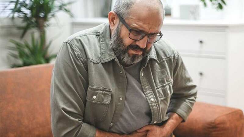 An ache in your abdomen is a key symptom (Image: Getty Images)