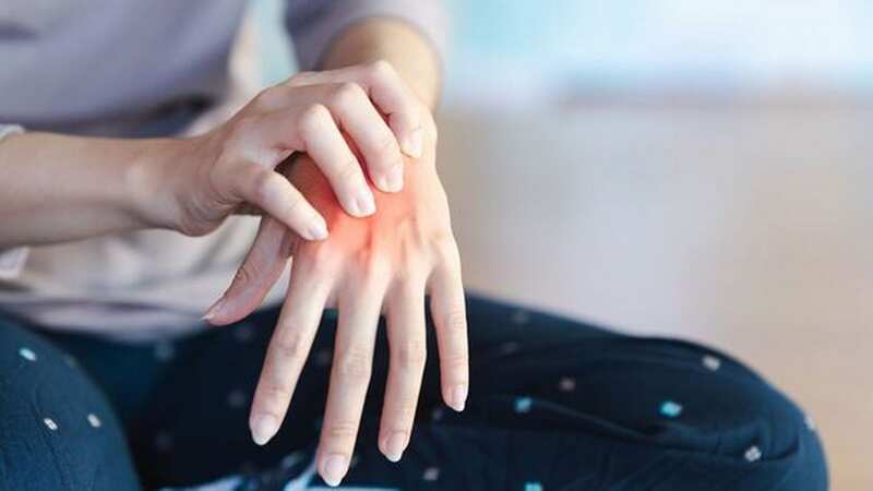A woman has pain in her palm because of a pinched nerve in her hand [file image] (Image: Getty Images)