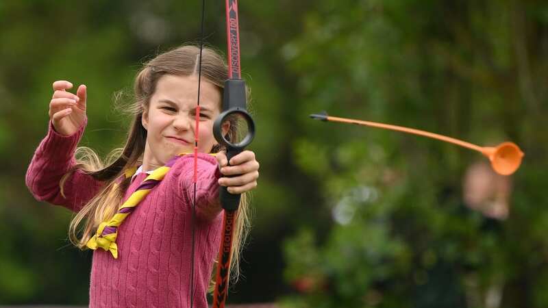 Princess Charlotte of Wales tries her hand at archery while taking part in the Big Help Out (Image: Getty Images)