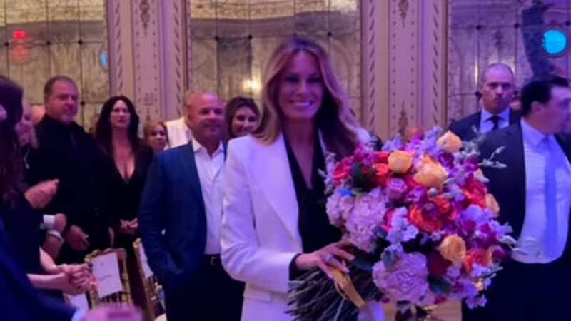 Melania poses with her huge bouquet of flowers presented to her by the Hungarian Prime Minister (Image: No credit)