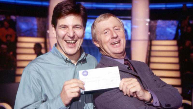 Chris Tarrant handing over the £1million cheque to Robert Brydges (Image: Press Association)