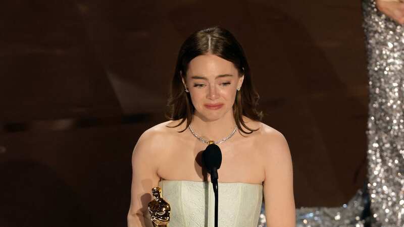 Emma Stone suffers awkward wardrobe malfunction as she wins Best Actress award