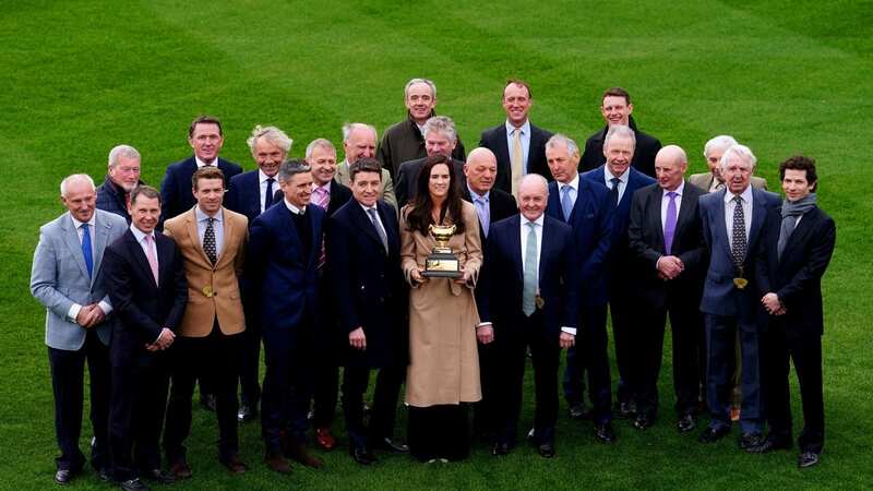 Rachael Blackmore holds the Cheltenham Gold Cup trophy surrounded by a number of other Cheltenham Gold Cup-winning jockeys (Image: David Davies/The Jockey Club)