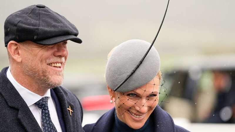 Zara and Mike Tindall tried to make the best of it as they rocked up at Cheltenham racecourse today in the pouring rain (Image: Dave Shopland/REX/Shutterstock)