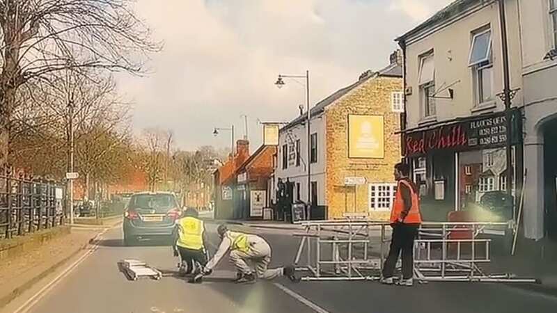 Scaffolding collapses launching workers 25ft on to road inches away from traffic