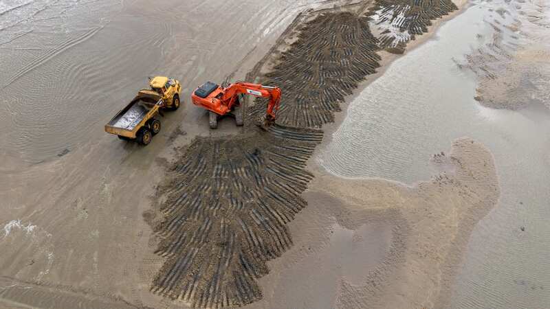 Heavy machinery is used to replace sand lost during winter (Image: Robin Morrison/SWNS)