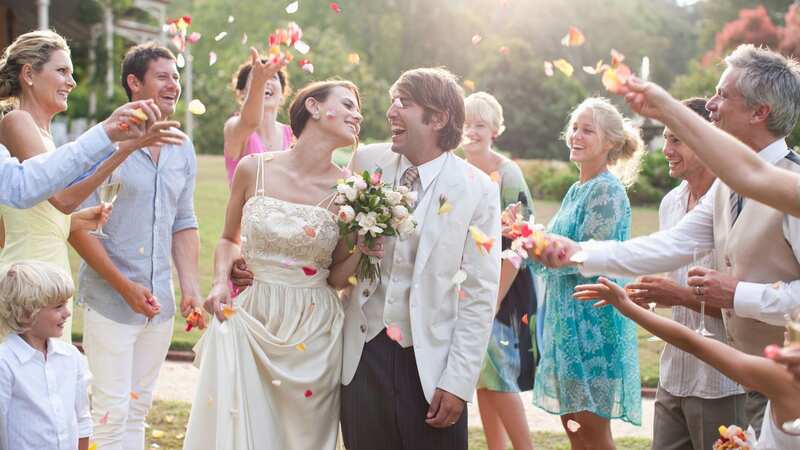 Guests throwing rose petals on bride and groom [file image] (Image: Getty Images)