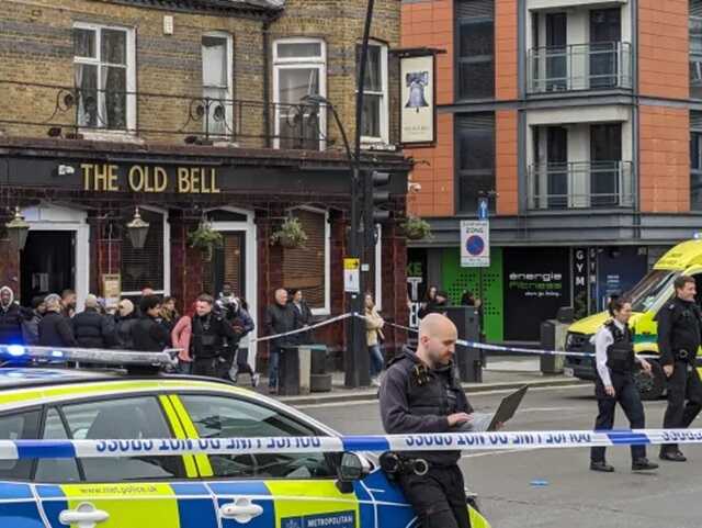 Police have closed a road near a London Overground station following a stabbing incident that left two people injured