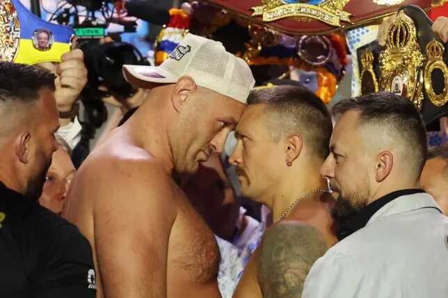 Tyson Fury and Oleksandr Usyk separated by security during fiery weigh-in