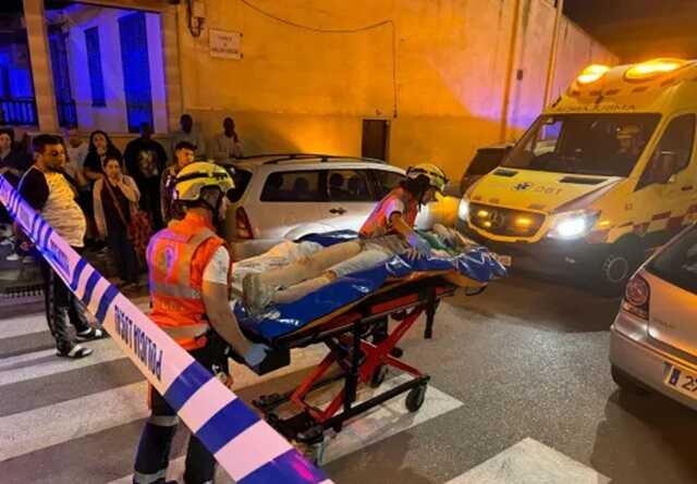 An injured person being transported on a stretcher from the site of the collapse (Picture: CRONICABALEAR/SOLARPIX.COM)