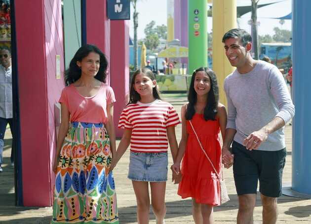 British Prime Minister Rishi Sunak, his wife, Akshata Murty (left), and daughters Anoushka and Krishna, walk together at Santa Monica Pier in Santa Monica, California, on their summer holiday on Aug. 3, 2023. | Pool photo by Emma McIntyre