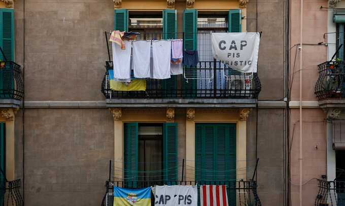 Banners reading ‘No tourist flats’ hang from a balcony in the Barcelona neighbourhood of Barceloneta. Photograph: Pau Barrena/AFP/Getty Images