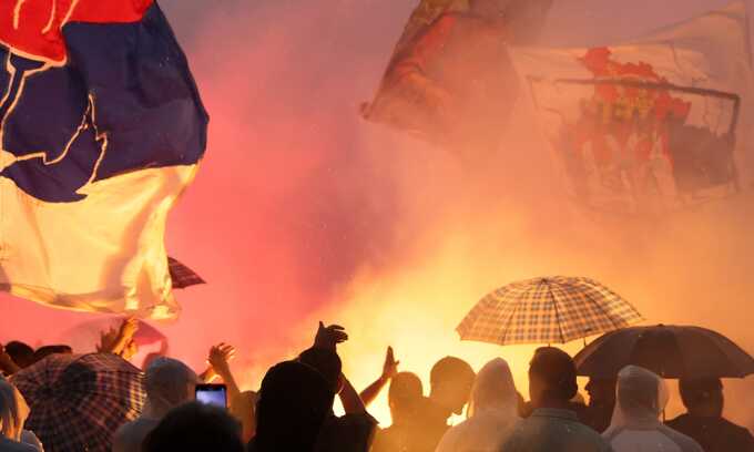 Protesters in Belgrade set off flares during a rally against the Mirëdita Dobar Dan arts festival. Photograph: Andrej Čukić/EPA