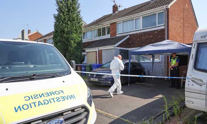 Police and forensic officers at the scene in Hednesford, Staffordshire. Photograph: SWNS