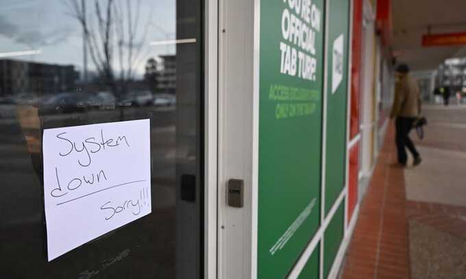 A sign notifies customers of IT issues at a store in Canberra, Australia. Photograph: Lukas Coch/EPA