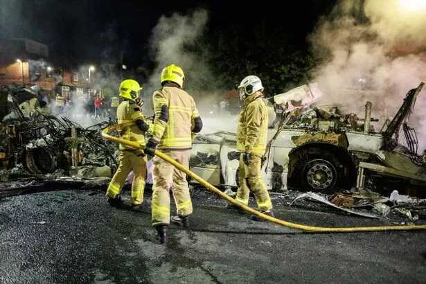 Firefighters extinguish flames from a bus ( Image: Joel Goodman/LNP)