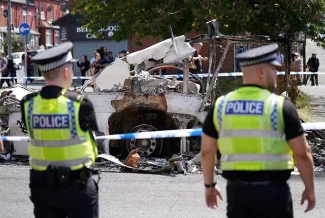 Images from the scene of the riots shows one car burnt to a crisp ( Image: Tom Maddick / SWNS)