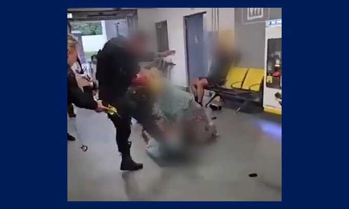 A still from a video of a police officer kicking a man on the ground at Manchester Airport. Photograph: Social media