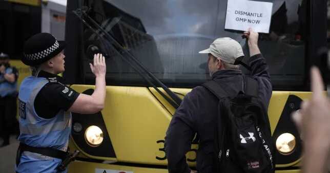 Protestors block the tram tracks, during a demonstration in the wake of a video showing a police officer kicking a man as he was being detained at Manchester Airport (Picture: Getty Images Europe)