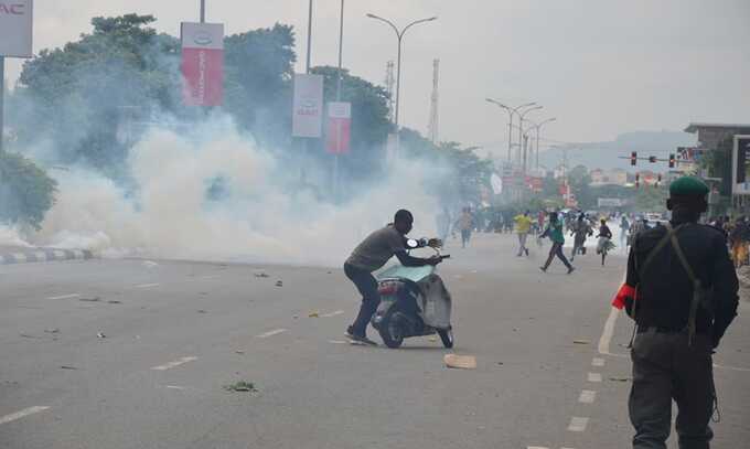 Police fire teargas during a protest in Abuja, Nigeria. Photograph: Olamikan Gbemiga/AP