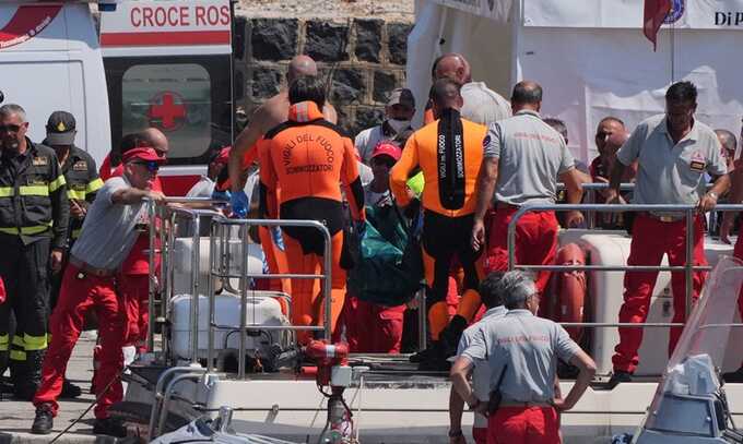 Rescue workers return to port in Porticello after retrieving a body, believed to be Hannah Lynch, from the Bayesian. Photograph: Jonathan Brady/PA