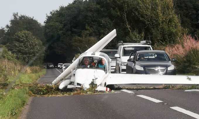 Two pilots survive light aircraft crash on a busy road in Gloucestershire