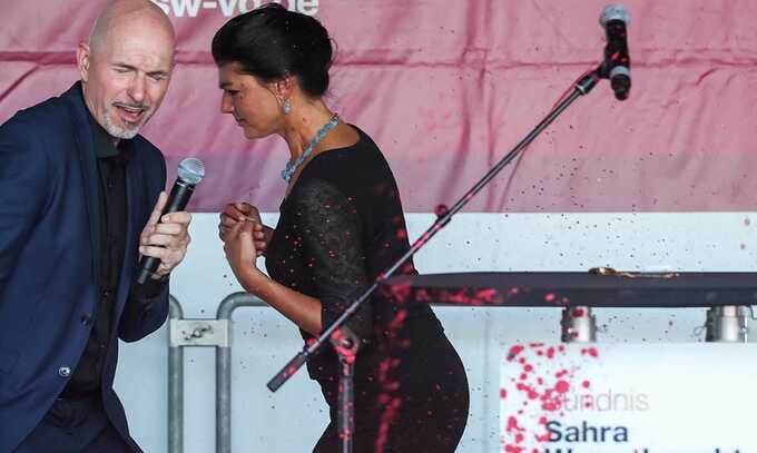 Sahra Wagenknecht and party colleague Steffen Quasebarth react on stage as they are sprayed with red paint during a campaign event for the upcoming state elections, in Erfurt, eastern Germany Photograph: Ronny Hartmann/AFP/Getty Images