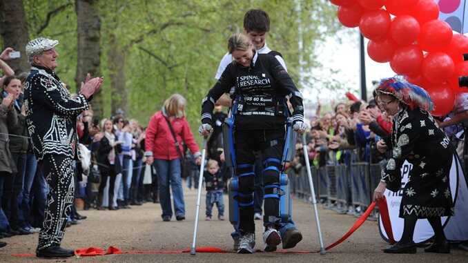 Claire Lomas crosses the finish line of the London Marathon with the aid of her husband Dan, 17 days after the race began in 2012. File pic: PA