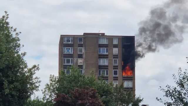 Flames emerged from the upper floors of the apartment building (Picture: @wherethecatis)