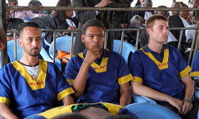 (L-r) Benjamin Zalman-Polun, Marcel Malanga and Tyler Thompson Jr awaiting verdicts in their trial in Kinshasa on Friday. Photograph: Justin Makangara/Reuters