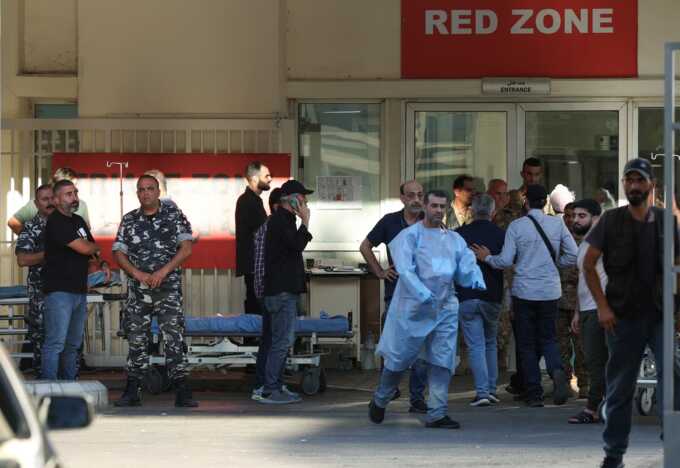 People gathered outside a hospital receiving wounded people in Beirut. Photograph: Mohamed Azakir/Reuters