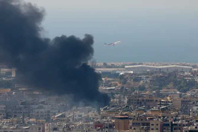 Smoke rises in Beirut’s southern suburbs after a strikeCredit: Reuters