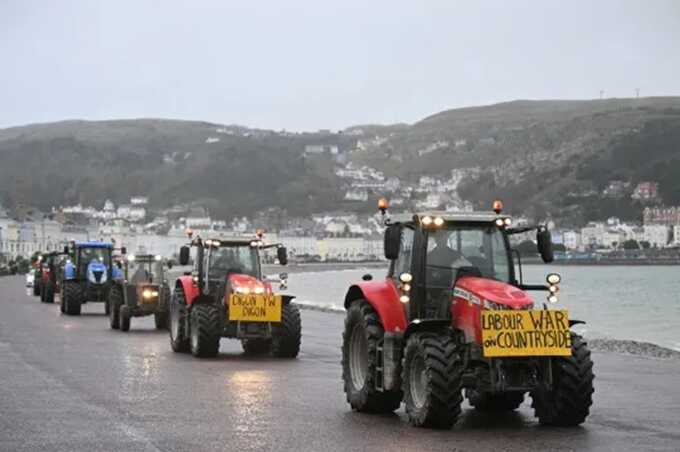 Tractors are driven along the promenade to the venue of the Welsh Labour Party conference in Llandudno (Picture: AFP via Getty Images)