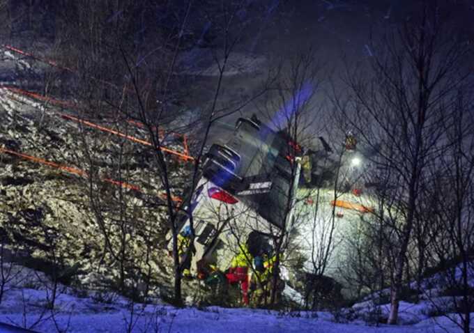 Rescuers work to save bus passengers after crash kills at least three