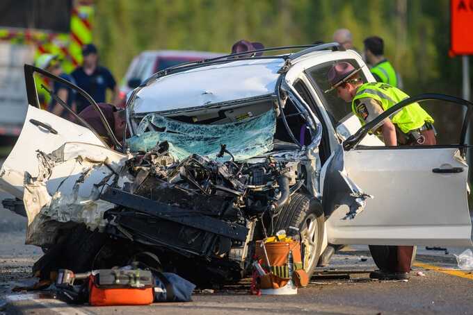 Woman killed in early-morning collision between her car and a bus