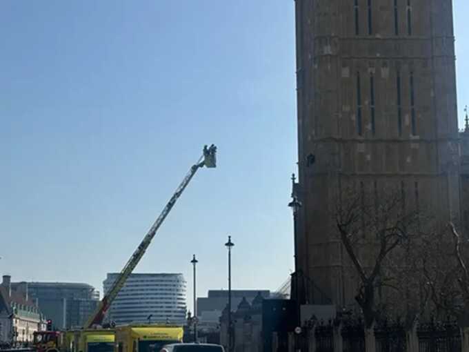 Barefoot individual seen ascending Big Ben while holding the Palestinian flag