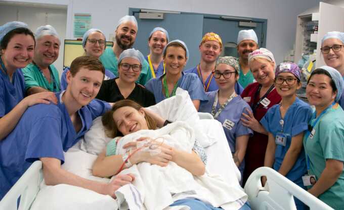 Grace and Angus Davidson with the hospital team at the birth of baby Amy. Pic: Womb Transplant UK/PA