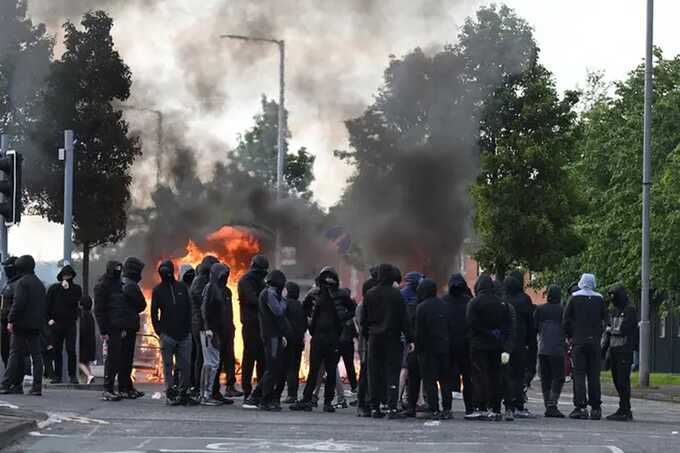 Belfast stabbing fallout: masked mobs torch migrant homes and businesses