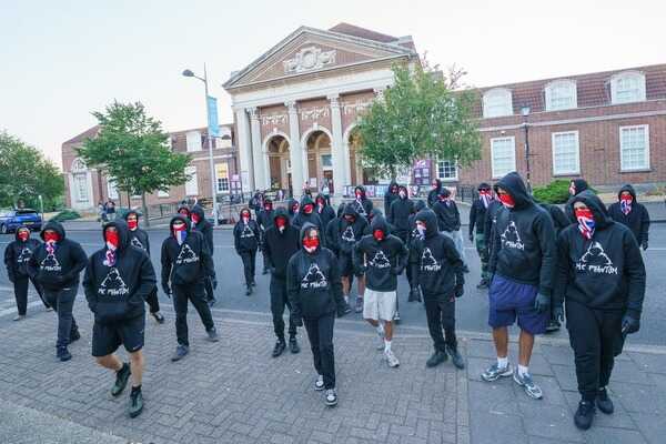 More than 50 masked protesters gather outside Clacton Town Hall before Farage victory