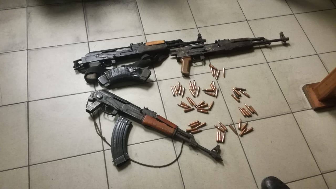 A cache of illegal firearms found by police during a raid on suspected assassin’s home