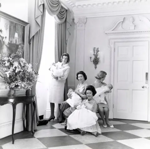 Lord Snowdon Queen Elizabeth II, Princess Margaret, Princess Alexandra and The Duchess of Kent holding their newborn babies
