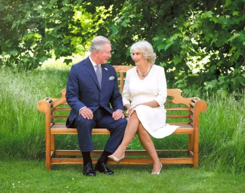 Hugo Burnand/Royal Household King Charles III and Queen Camilla pictured in 2018, sitting on a bench
