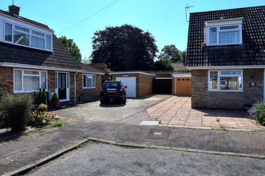 The boundary and car park between the two homes is seen in a photograph 