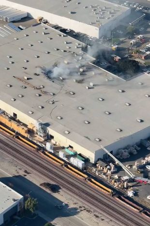 Smoke billows from warehouse in footage captured by reporter Chris Cristi of ABC7 Eyewitness News eiqrriqqkiqxrinv