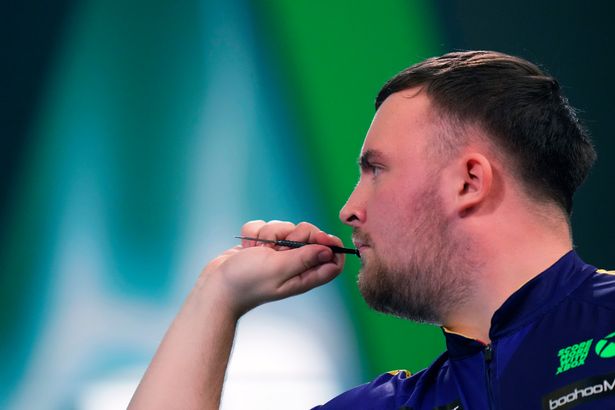 Luke Littler of England throws his dart during the semifinal match against Stephen Bunting of England, at the World Darts Championship in London, Thursday, Jan. 2, 2025