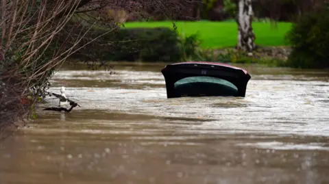 PA Media A car submerged in the River Devon in Bottesford