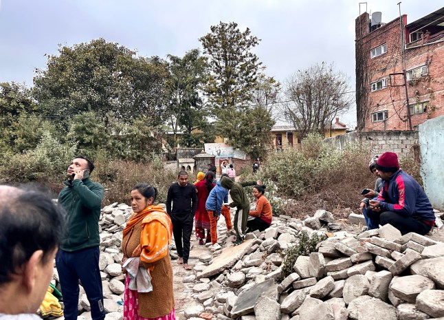 People gather in an open area following earthquake tremors in Kathmandu, in the early hours on January 7, 2025. A powerful earthquake in China’s remote Tibet region killed at least 32 people and collapsed 