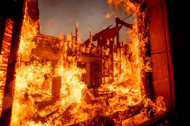 The Palisades Fire burns a residence in the Pacific Palisades neighborhood of Los Angeles, Tuesday, Jan. 7, 2025. (AP Photo/Ethan Swope) qhiddxiqhxiqzuinv